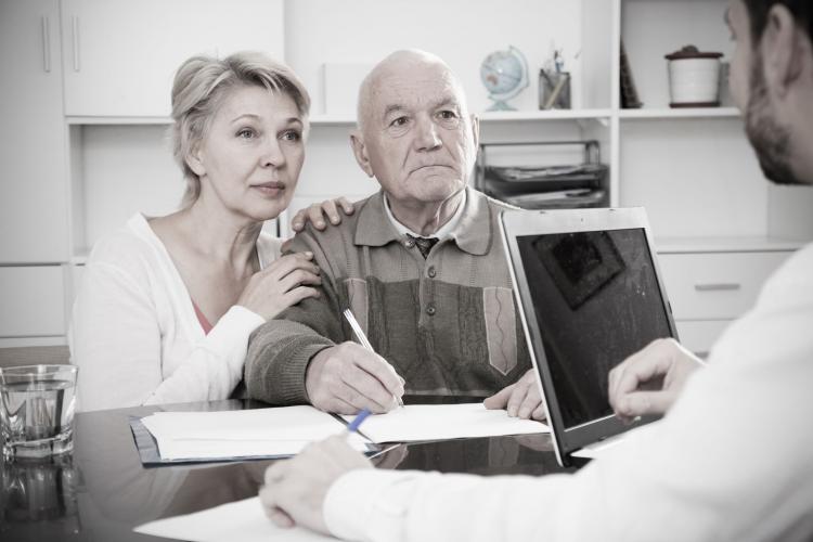 An older couple consult a health professional